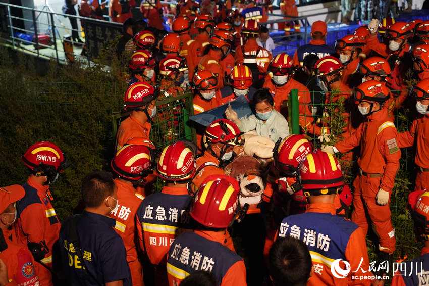 9月5日晚，雅安消防支隊(duì)在新民鄉(xiāng)碼頭，消防救援人員與多方救援力量一起運(yùn)送傷員。鄭竺青攝